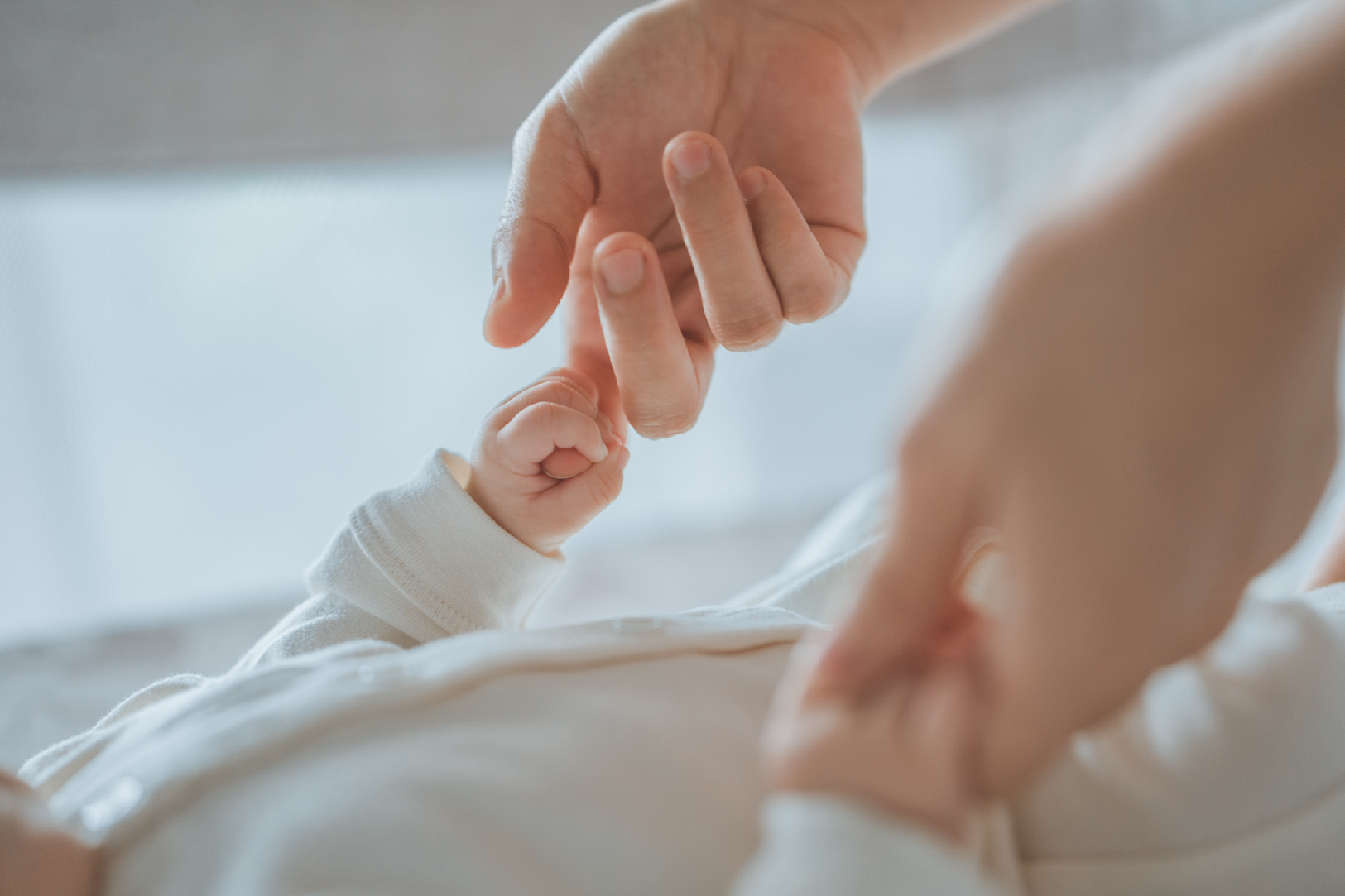 Person holding a baby's hands