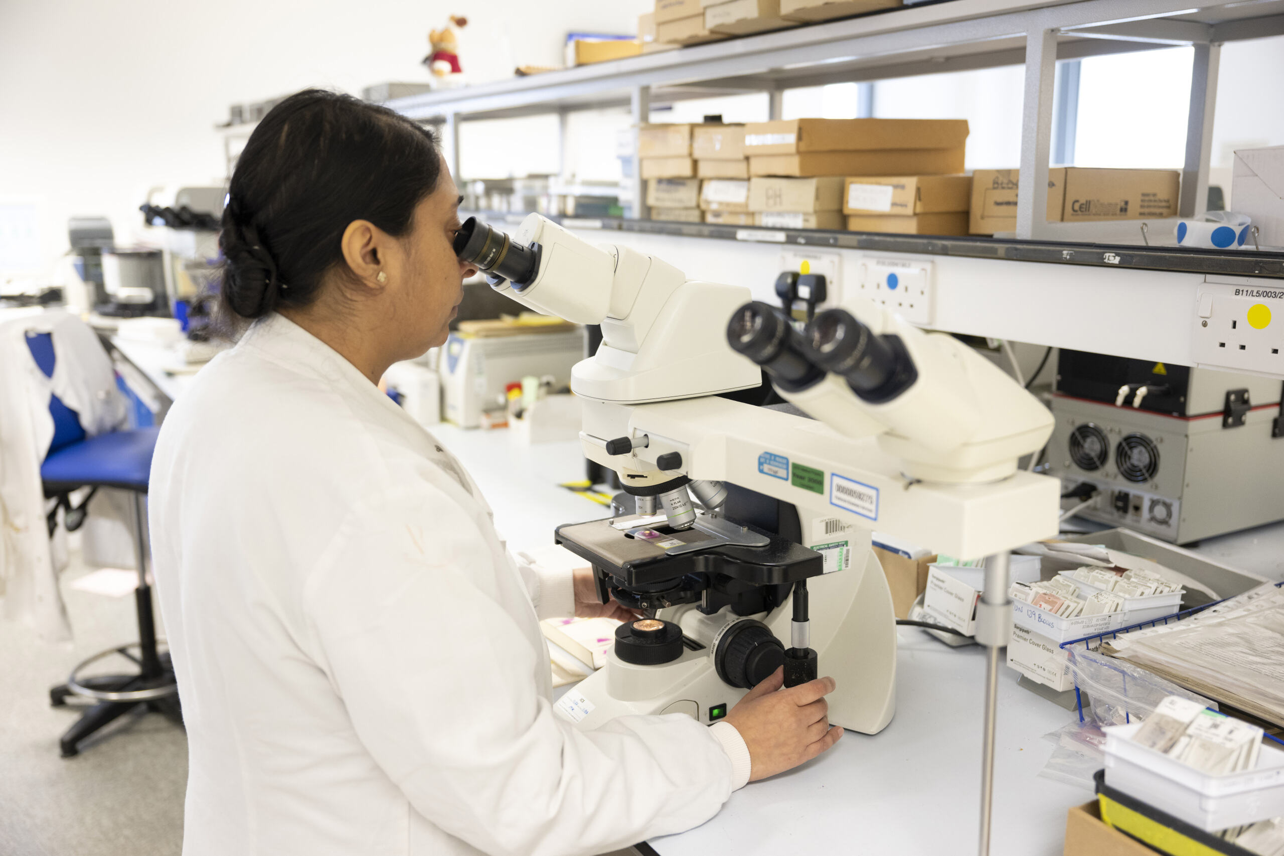 Student working with a microscope in the Histopathology Lab at Leeds Hospital